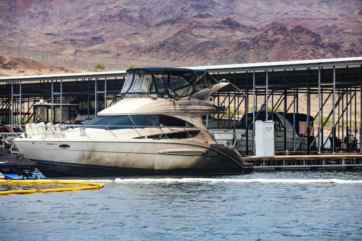 A damaged boat at the scene where a fire sank 10 boats, did damage to several more and caused m ...