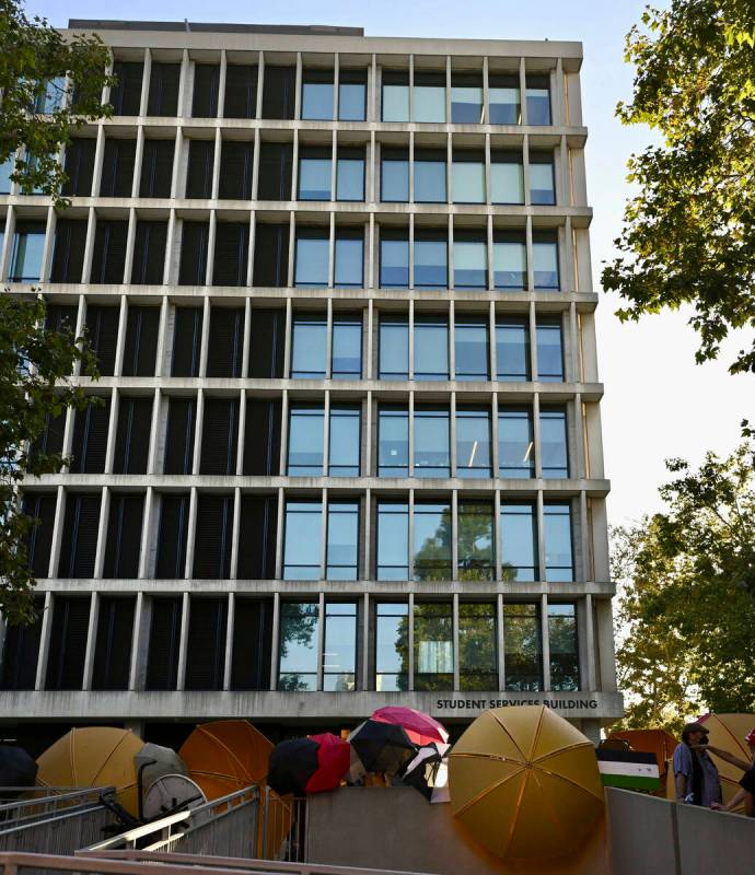 Pro-Palestinian student protesters barricade the entrance to the student services building whil ...