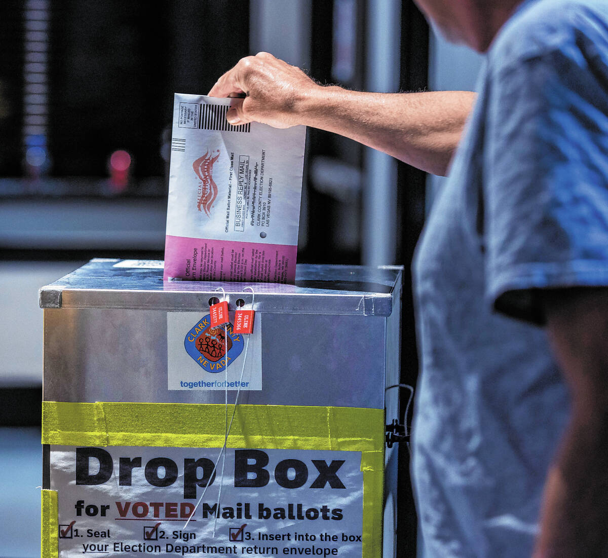 A voter drops off his mail ballot during Nevada's primary election day at the polls within the ...