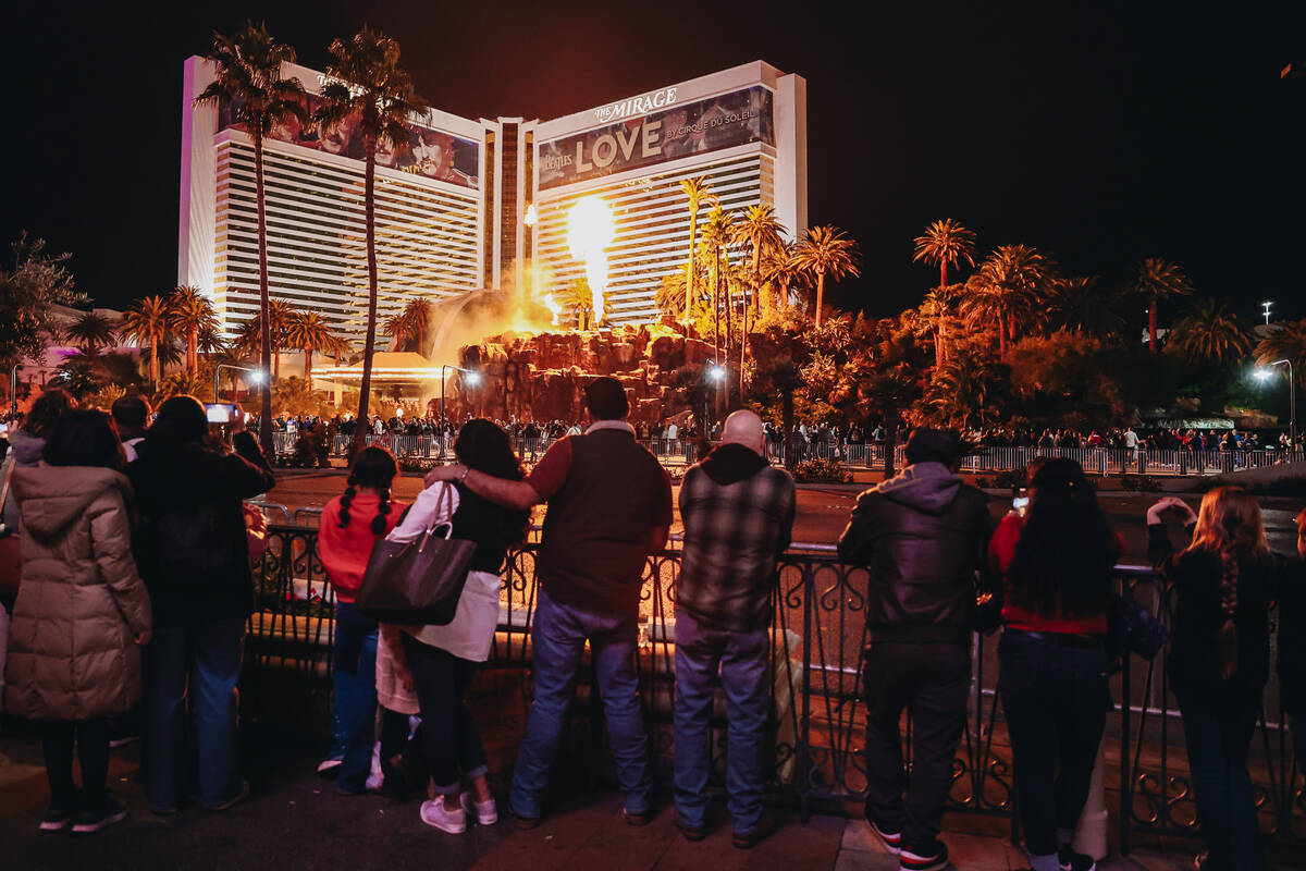 People watch the Mirage volcano go off Sunday, Dec. 31, 2023, in Las Vegas. (Madeline Carter/La ...