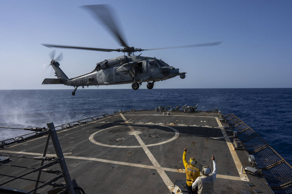 A HSC-7 helicopter lands on the Arleigh Burke-class guided missile destroyer USS Laboon in the ...