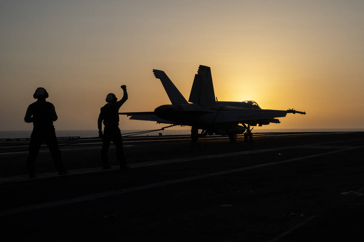 A fighter jet lands on the USS Dwight D. Eisenhower, also known as "IKE," in the Red ...