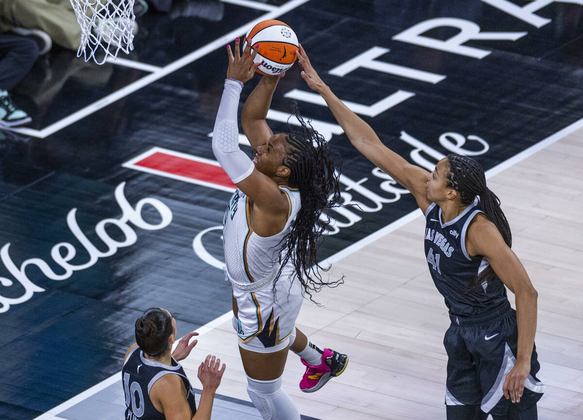 New York Liberty forward Kayla Thornton (5) has a shot attempt blocked from behind by Aces cent ...