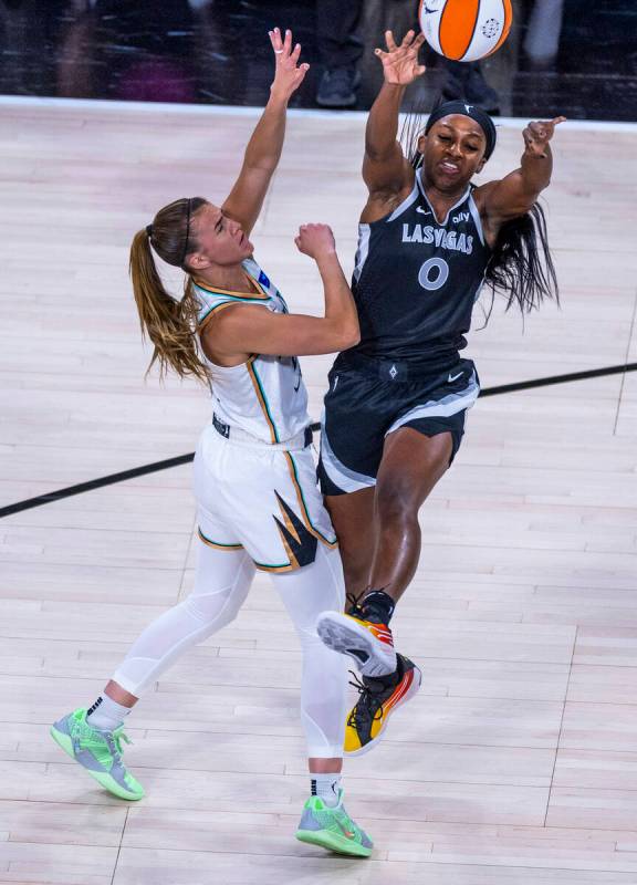 Aces guard Jackie Young (0) gets off a pass over New York Liberty guard Sabrina Ionescu (20) du ...