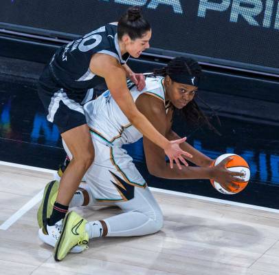 New York Liberty forward Jonquel Jones (35) looks to pass from her kness as Aces guard Kelsey P ...