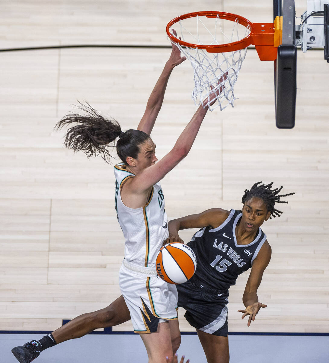 Aces guard Tiffany Hayes (15) passes around New York Liberty forward Breanna Stewart (30) durin ...
