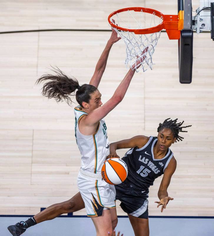 Aces guard Tiffany Hayes (15) passes around New York Liberty forward Breanna Stewart (30) durin ...