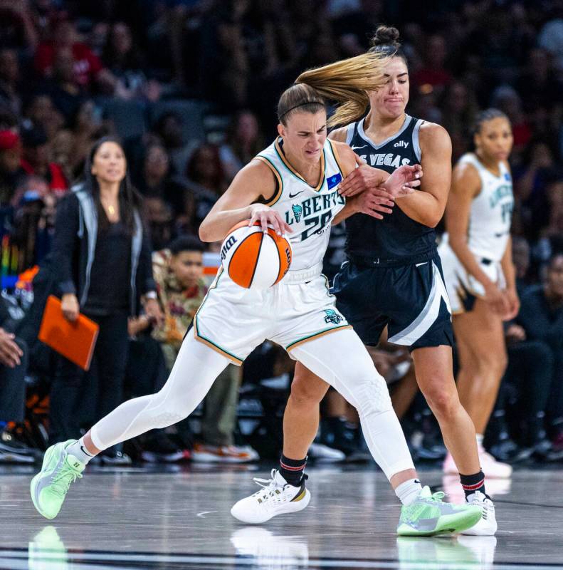 New York Liberty guard Sabrina Ionescu (20) fights off Aces guard Kelsey Plum (10) during the s ...