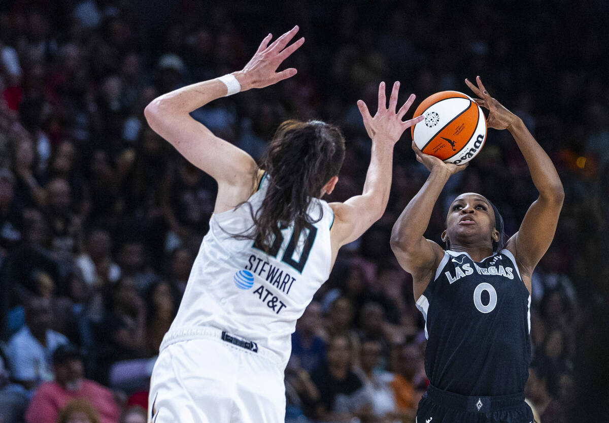Aces guard Jackie Young (0) looks to shoot over New York Liberty forward Breanna Stewart (30) d ...