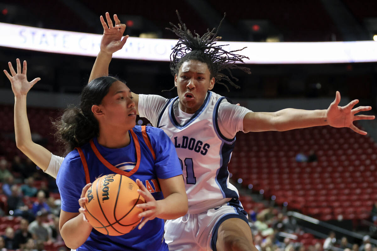 Bishop Gorman's Aliitasi Fakatoumafi (34) looks to pass while Centennial's Cici Ajomale (21) de ...