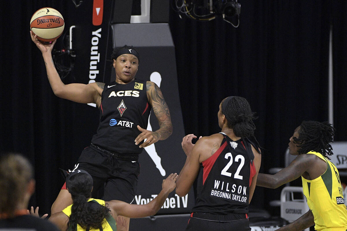 Las Vegas Aces forward Emma Cannon, top left, passes the ball to center A'ja Wilson (22) as Sea ...