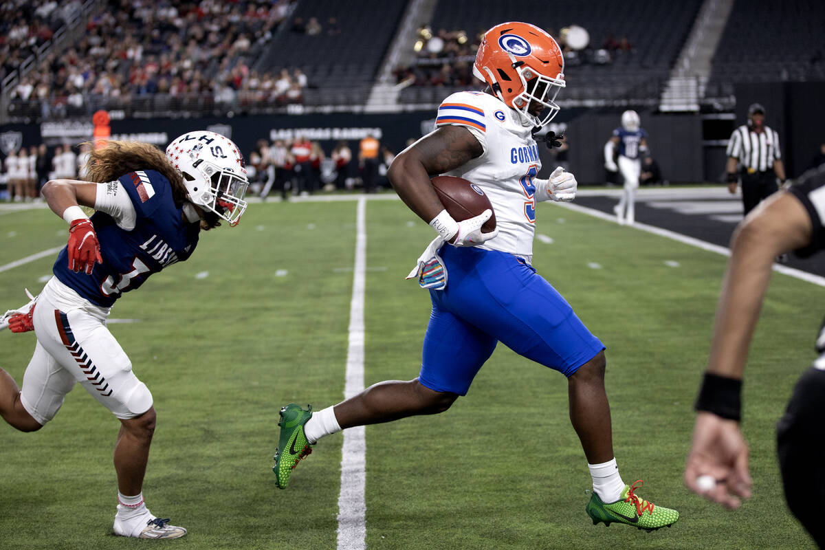 Bishop Gorman wide receiver Elija Lofton (9) runs the ball in for a touchdown followed by Liber ...