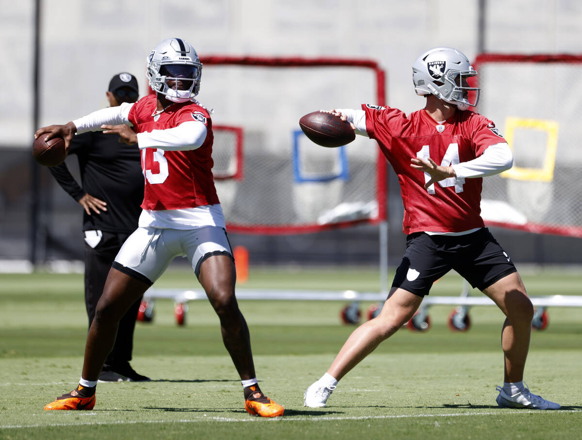 Raiders quarterbacks Anthony Brown Jr. (13) and Carter Bradley (14) prepare to throw the ball d ...