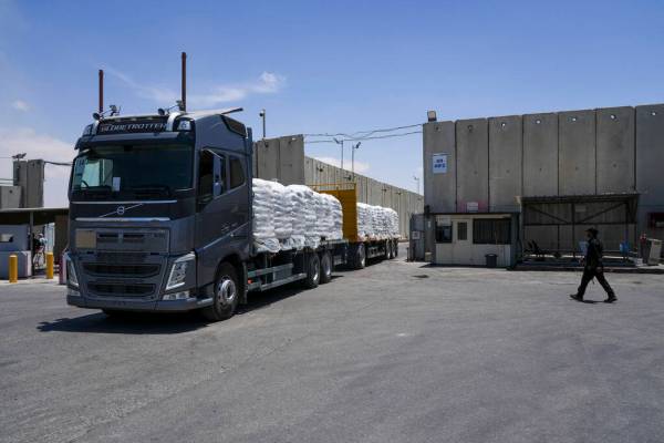 A truck with bundle of humanitarian aid for the Gaza Strip drive at the Kerem Shalom border cro ...