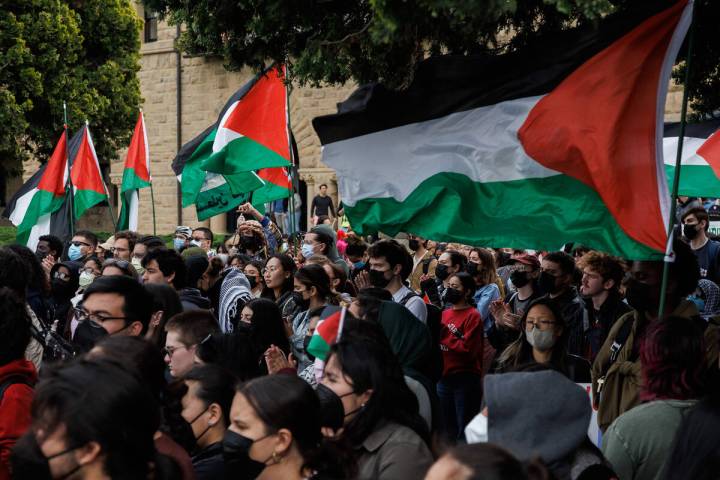 Pro-Palestinian demonstrators listens to a speaker as they protest at Stanford University urgin ...