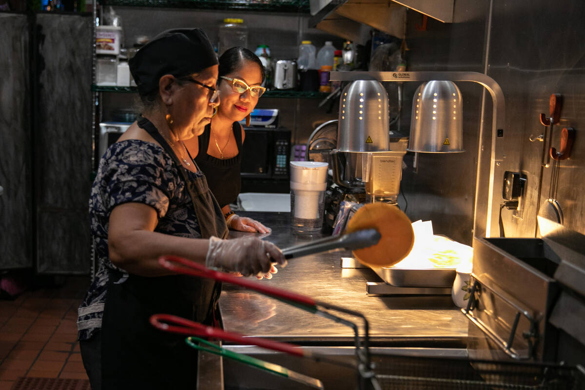 Zacil Vazquez, right, helps her mother Maria Vazquez prepare an order for a customer at their r ...
