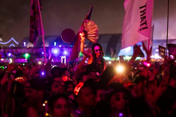 Attendees watch as David Guetta performs at the Kinetic Field stage during the first night of t ...