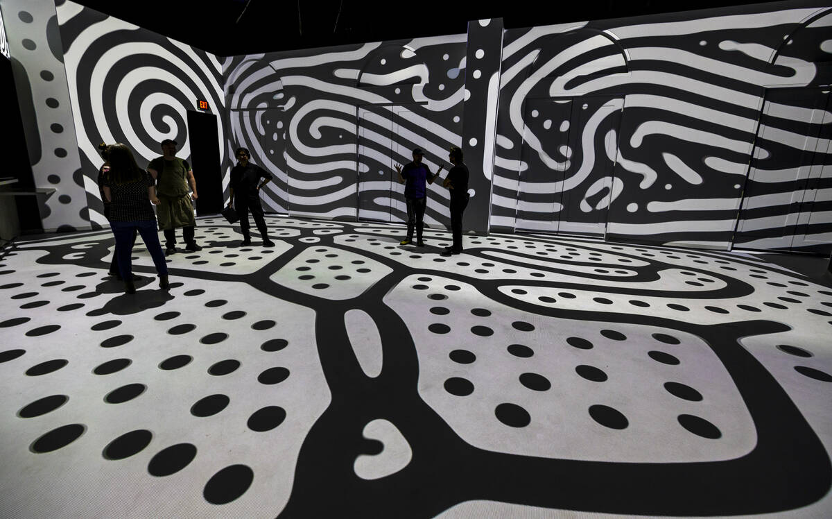 Projections of black and white lines and dots cover the floor and walls at Electric Playhouse, ...