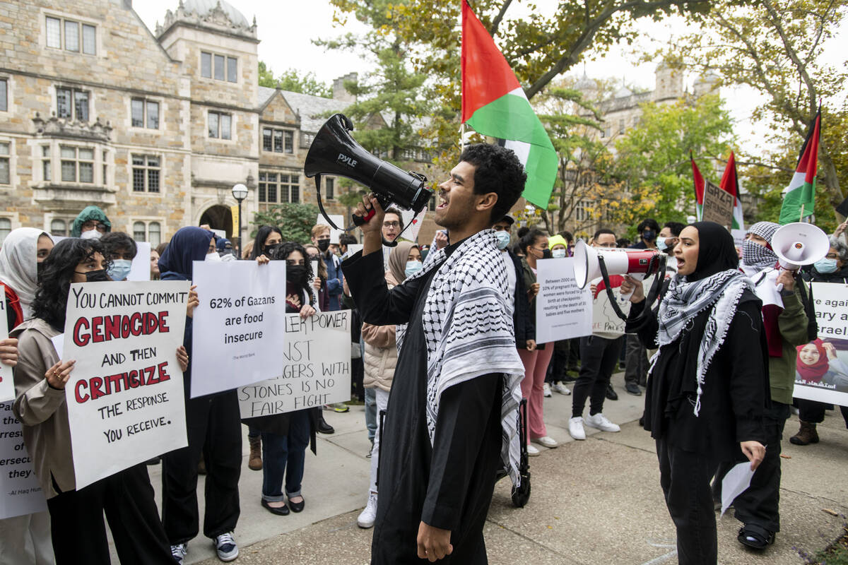 Pro-Palestinian demonstrators gather to protest University of Michigan President Santa Ono's "S ...