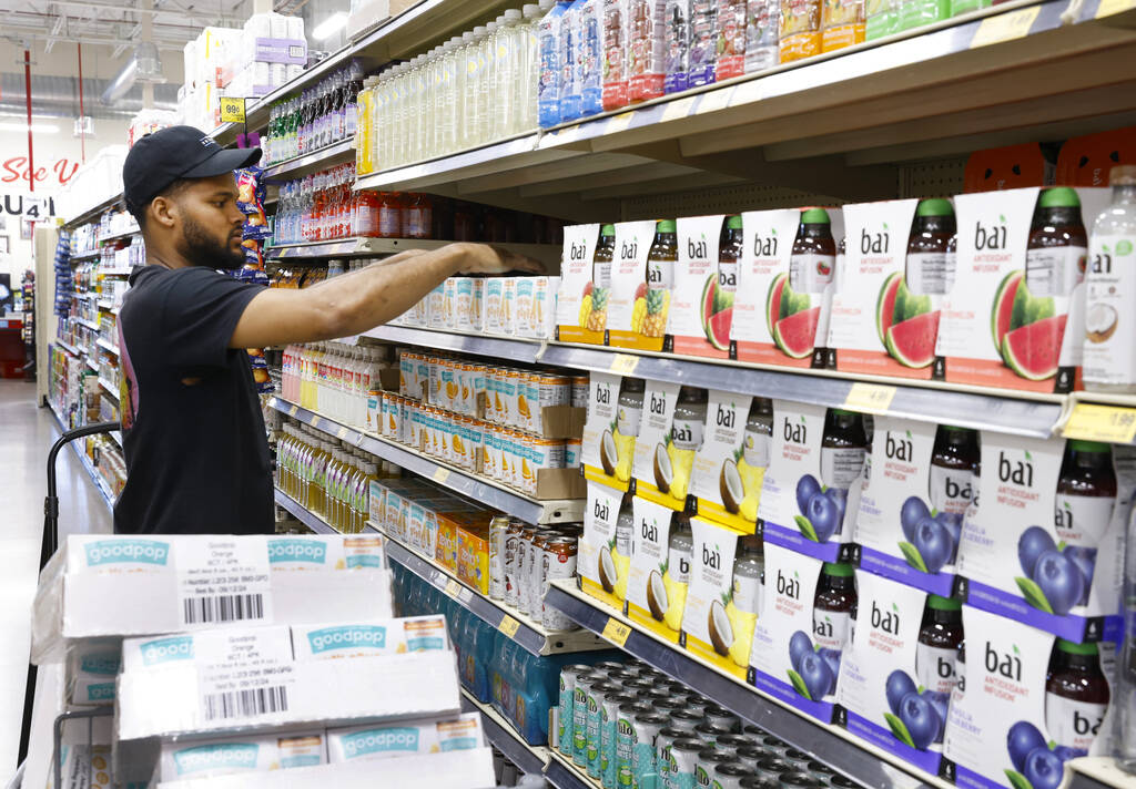 Miguel Perez stacks shelves in a fruit juice display at Grocery Outlet Bargain Market, on Wedne ...