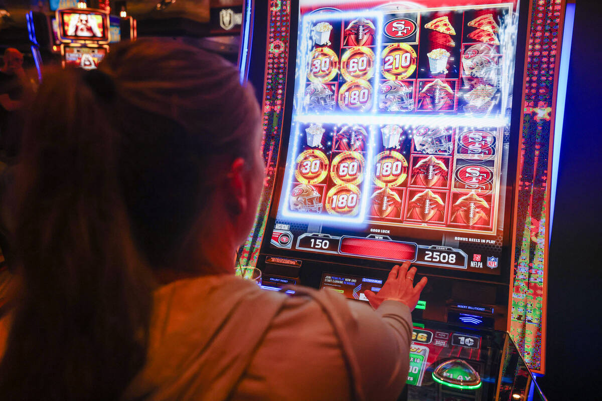 Candice Low plays the first Vegas NFL slot machine at the M Resort on Monday, Sept. 18, 2023, i ...