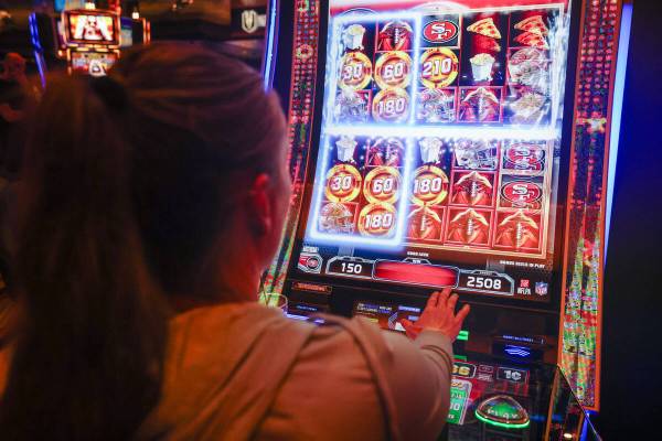 Candice Low plays the first Vegas NFL slot machine at the M Resort on Monday, Sept. 18, 2023, i ...