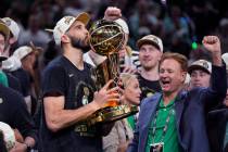 Boston Celtics forward Jayson Tatum kisses the Larry O'Brien Championship Trophy after Game 5 o ...