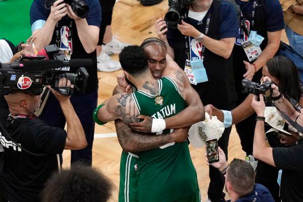 Boston Celtics' Jayson Tatum (0) hugs Oshae Brissett after defeating the Dallas Mavericks in Ga ...