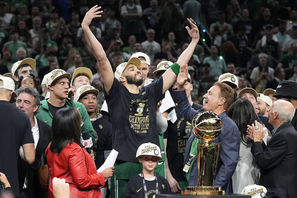 Boston Celtics forward Jayson Tatum, center, celebrates with to Celtics co-owner Stephen Pagliu ...