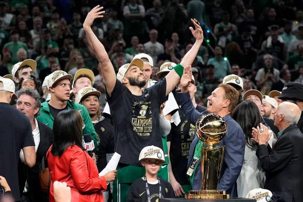 Boston Celtics forward Jayson Tatum, center, celebrates with to Celtics co-owner Stephen Pagliu ...