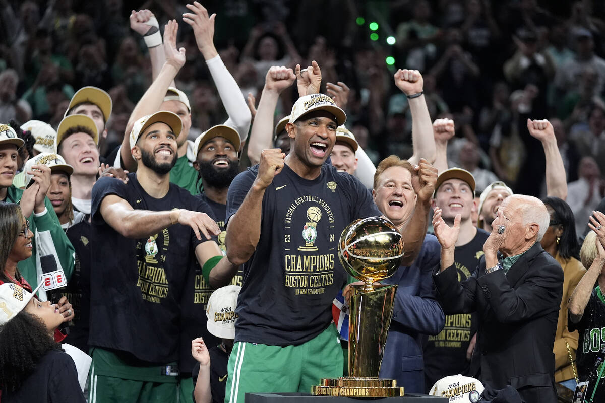 Boston Celtics center Al Horford, center, and forward Jayson Tatum, front center left, celebrat ...