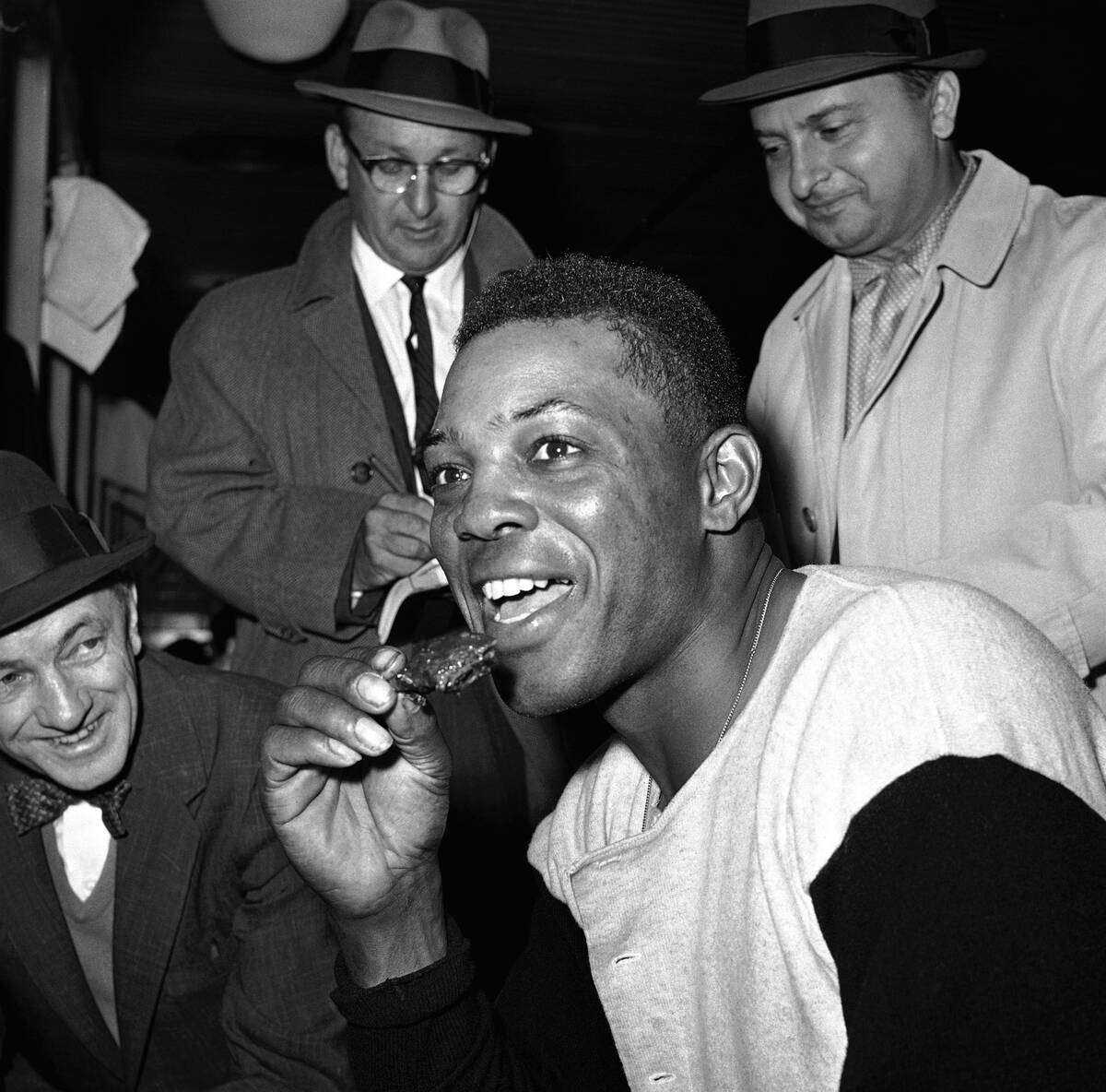 Giants outfielder, Willie Mays, smiles happily in the dressing room after he hit four home runs ...