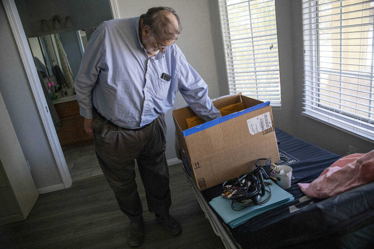 James Belnap, the widower of Marsha Belnap, looks through a box on top of his wife’s med ...