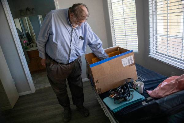 James Belnap, the widower of Marsha Belnap, looks through a box on top of his wife’s med ...