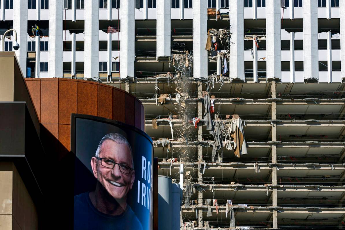 An old ad for Robert Irvine's Public House remains on the exterior as debris is pushed out of a ...