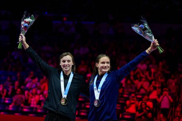 Katie Ledecky and Katie Grimes celerate after the women's 1,500-meter freestyle finals Wednesda ...