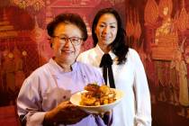 Lotus of Siam chef-owner Saipin Chutima, left, shows a dish of Garlic Prawns with her daughter ...