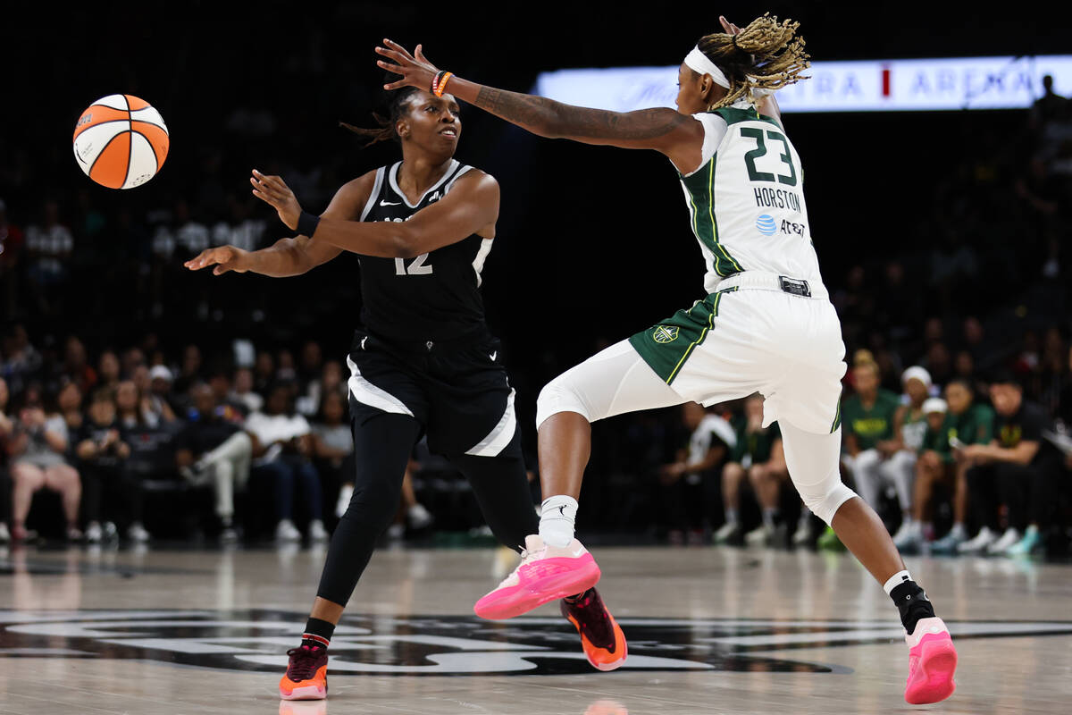 Las Vegas Aces guard Chelsea Gray (12) passes while Seattle Storm guard Jordan Horston (23) def ...