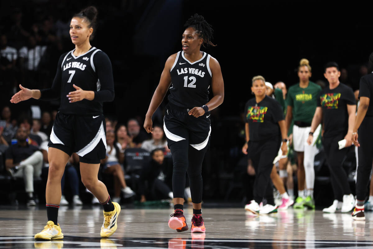 Las Vegas Aces guard Chelsea Gray (12) and forward Alysha Clark (7) celebrate after scoring dur ...