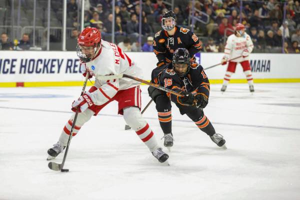 FILE - Boston University's Macklin Celebrini (71) skates with the puck in front of Rochester's ...
