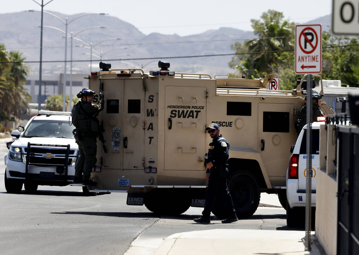 The Henderson Police Department SWAT team officers arrive where a shooting that involved police ...