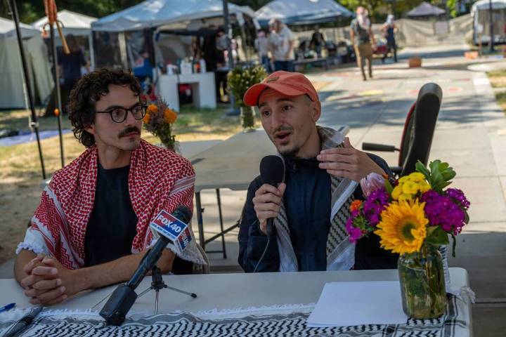 Stanford McConnehey, left, listens to Beshara Kehdi, right, speak as they announce that the Dav ...