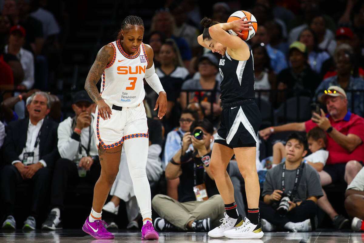 Las Vegas Aces guard Kelsey Plum, right, reacts after Connecticut Sun guard Tiffany Mitchell (3 ...