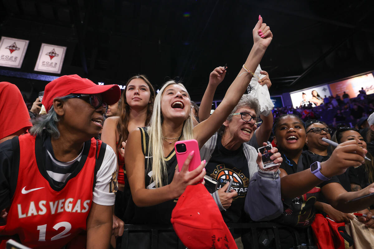 Las Vegas Aces fans shout for autographs after the Aces won a WNBA basketball game against the ...