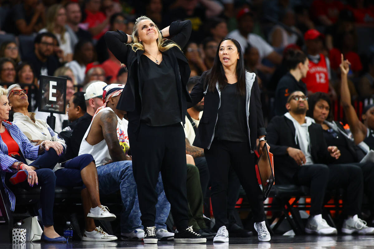 Las Vegas Aces head coach Becky Hammon, left, and assistant coach Natalie Nakase react to a fou ...