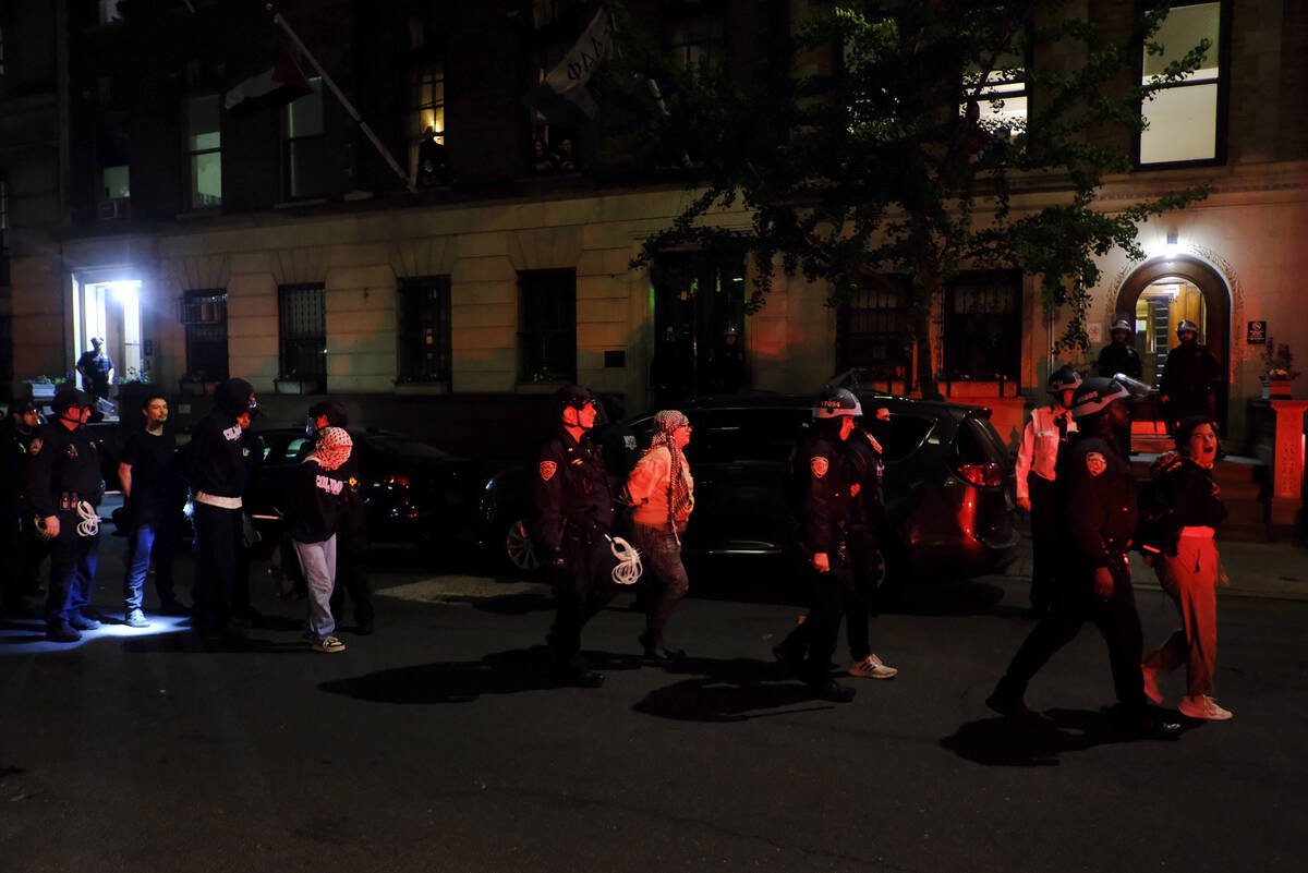 FILE - Members of the New York Police Department strategic response team escort protesters from ...