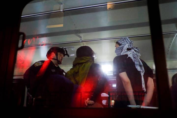 FILE - Members of the New York Police Department strategic response team load arrested proteste ...