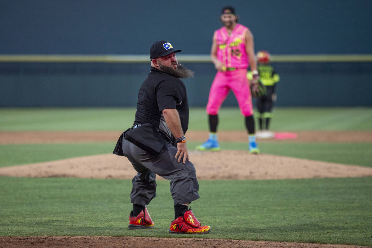 Umpire Vincent “Vinny” Chapman dances during the game between the Firefighters an ...