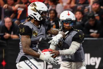 Vegas Knight Hawks quarterback Ja'Rome Johnson, right, hands the ball off to wide receiver Cale ...