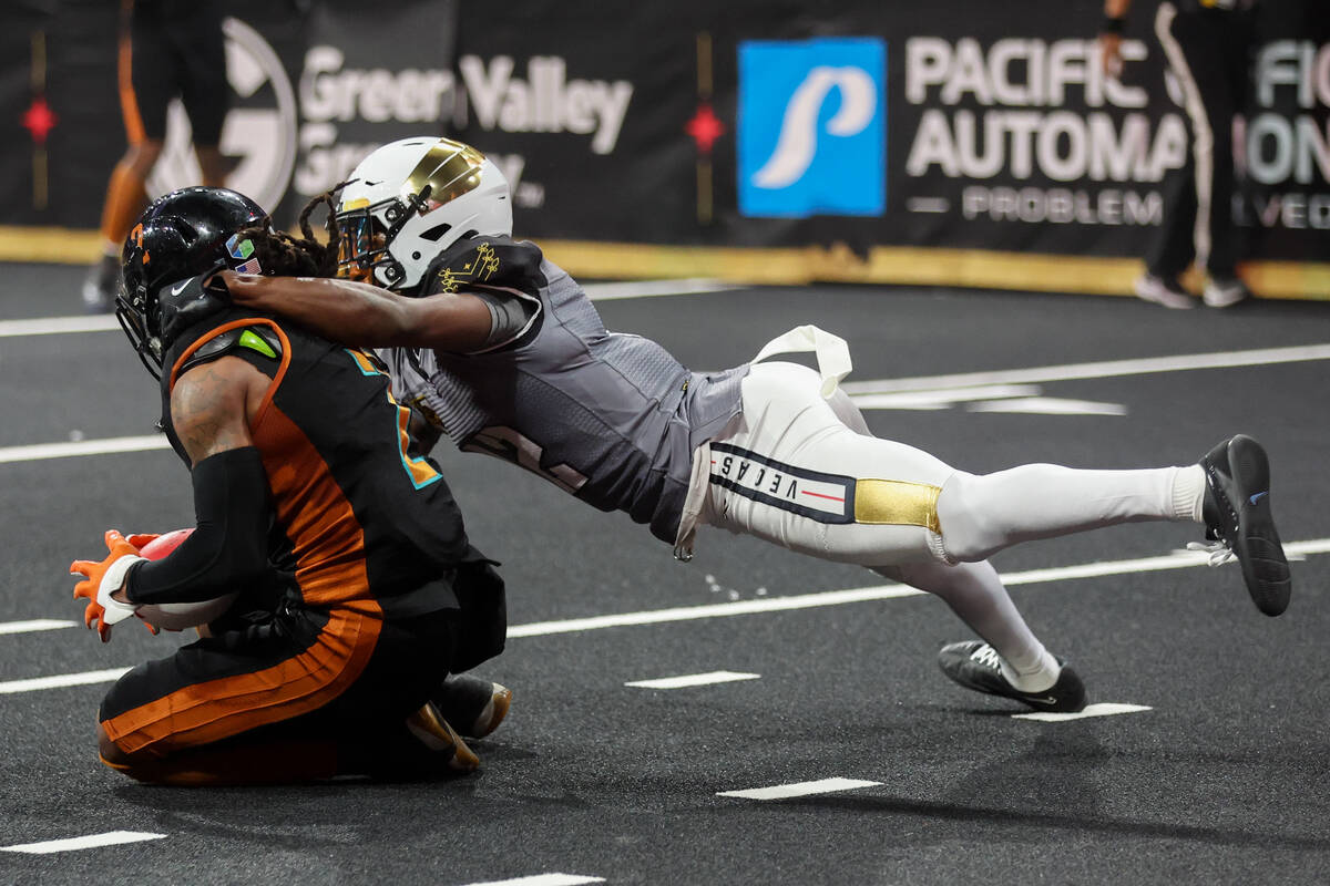 Vegas Knight Hawks defensive back James Ceasar, right, takes down Arizona Rattlers wide receive ...